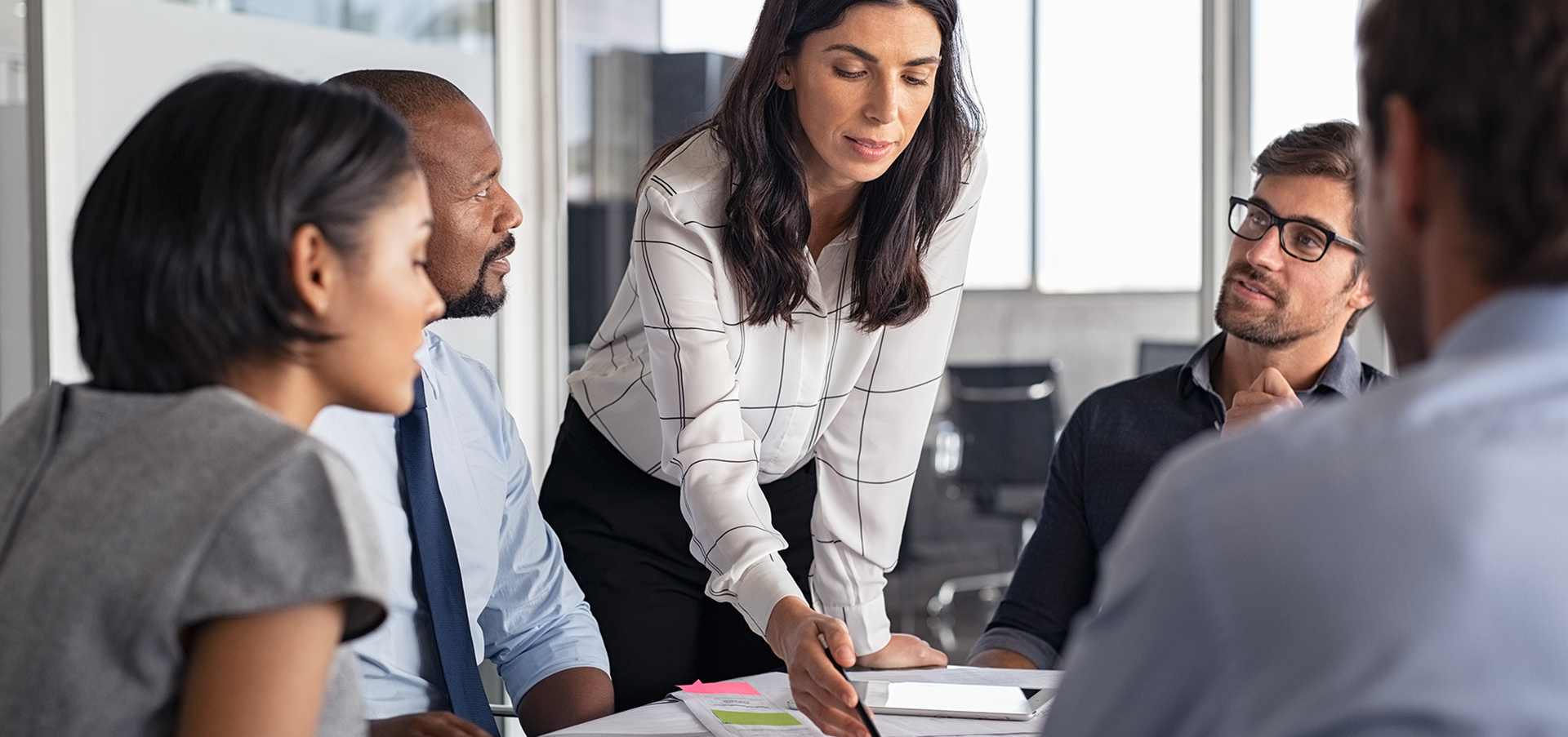 Architect working on blueprint with team