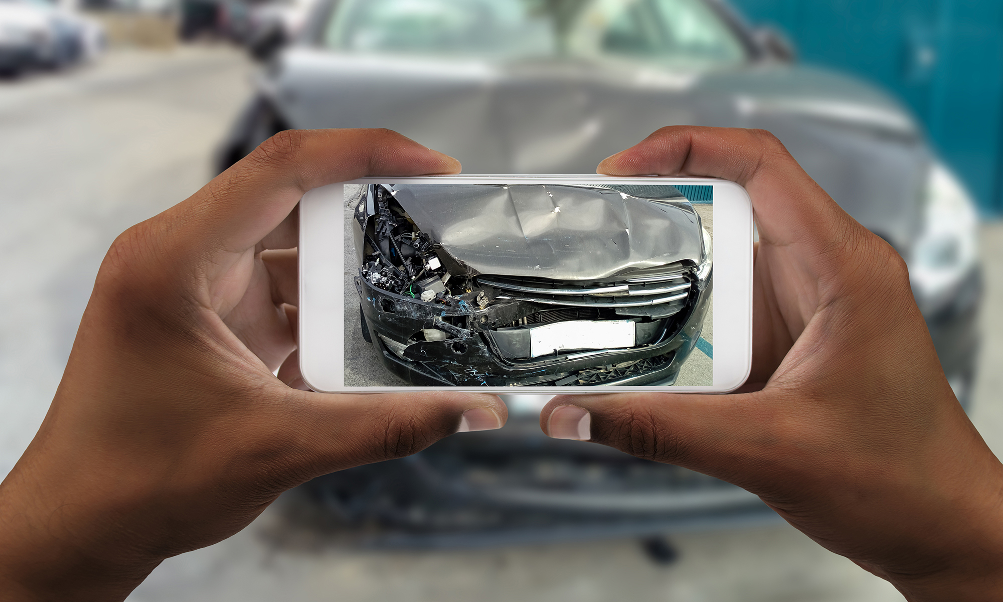 Man taking photo of his car with damages