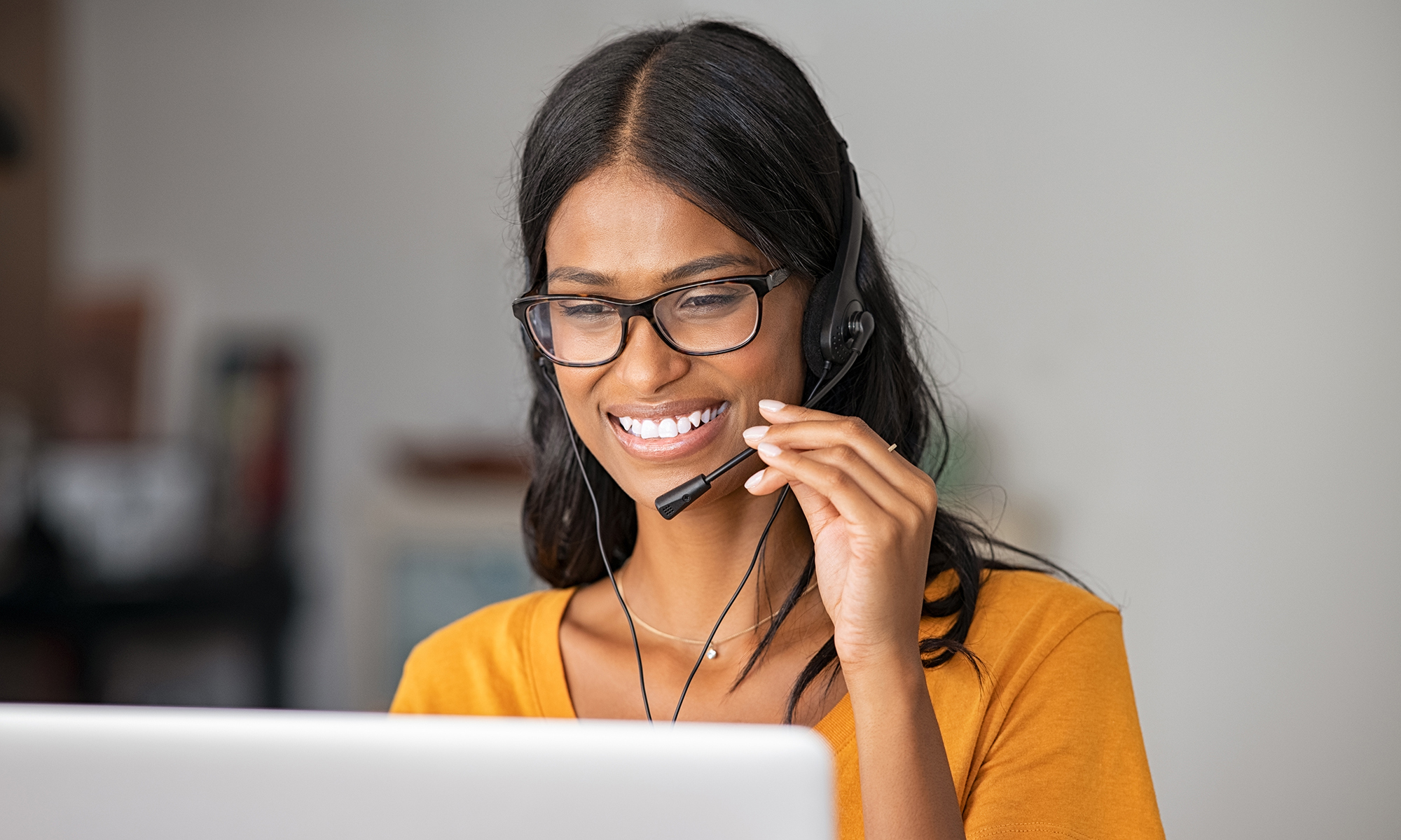 Happy indian woman working in a call center