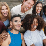Young diverse people having fun outdoor laughing together - Focus on gay man face