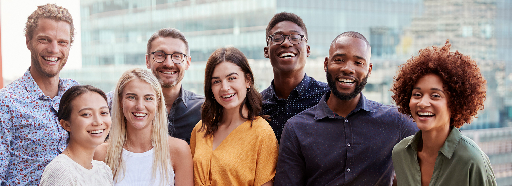 Group portrait of a creative business team standing outdoors, three quarter length, close up