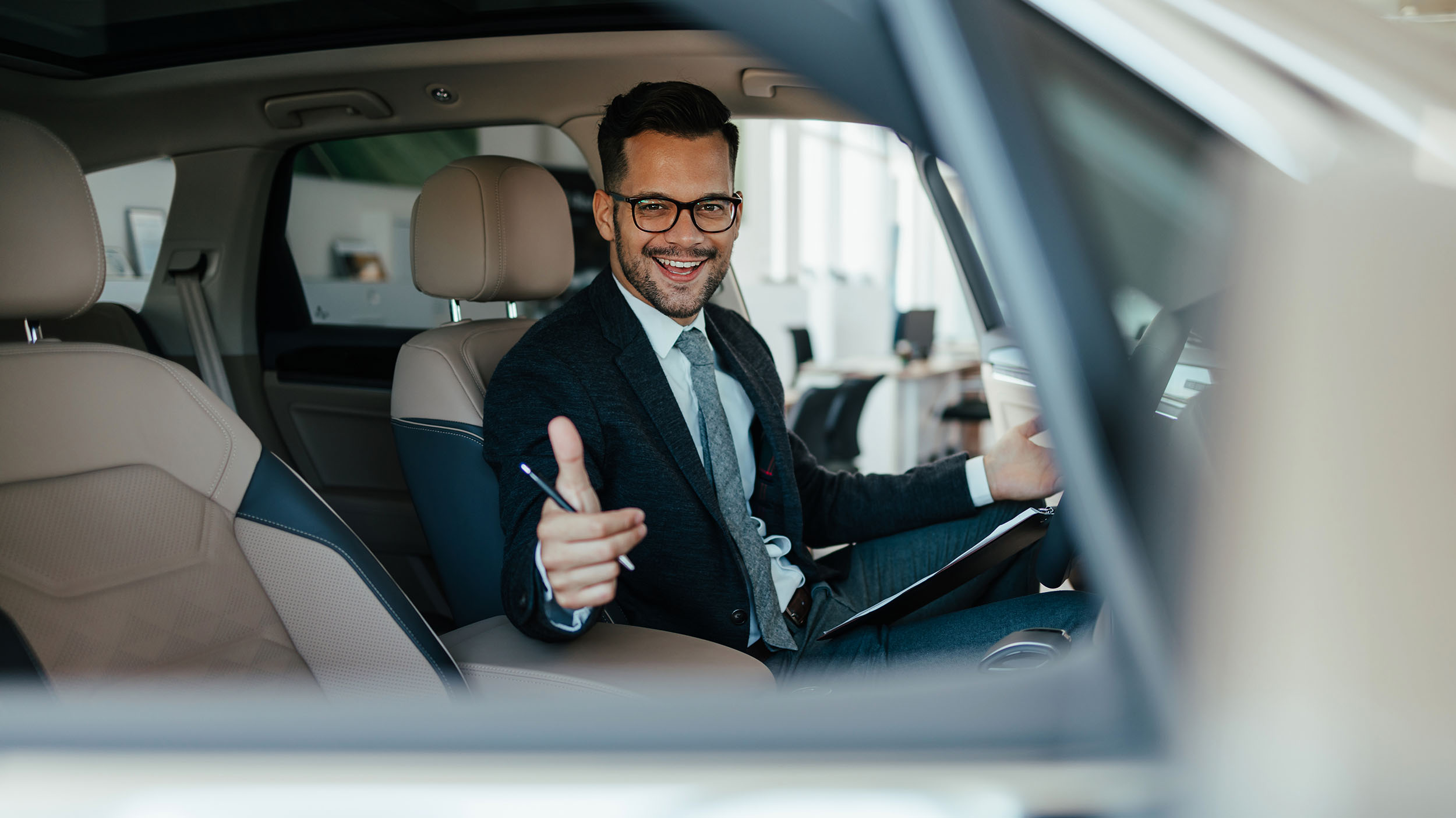 Car salesman checking new car