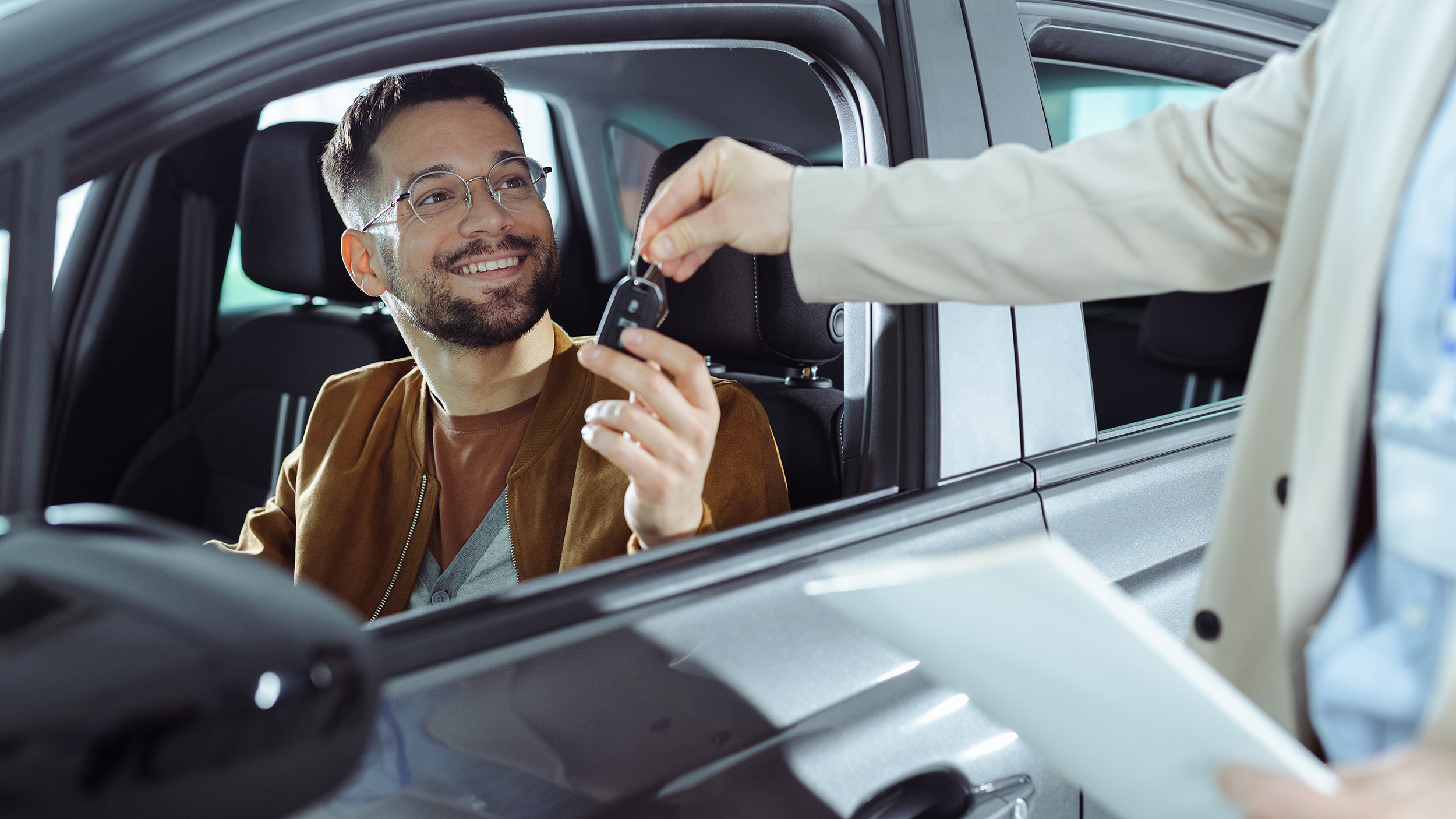 A young man buys a new car