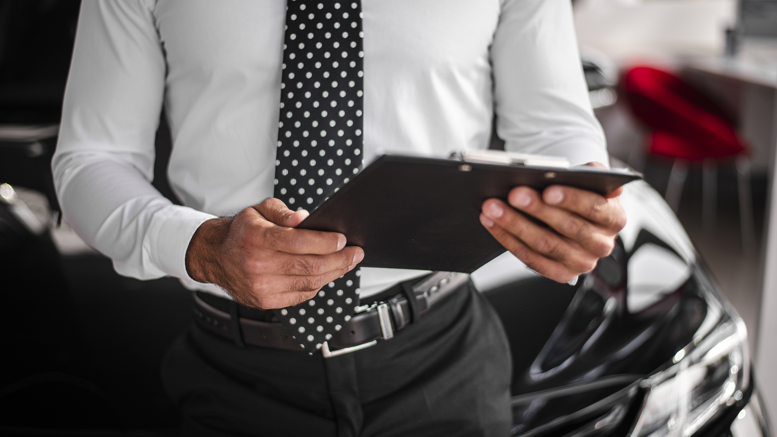 close-up-male-checking-clipboard