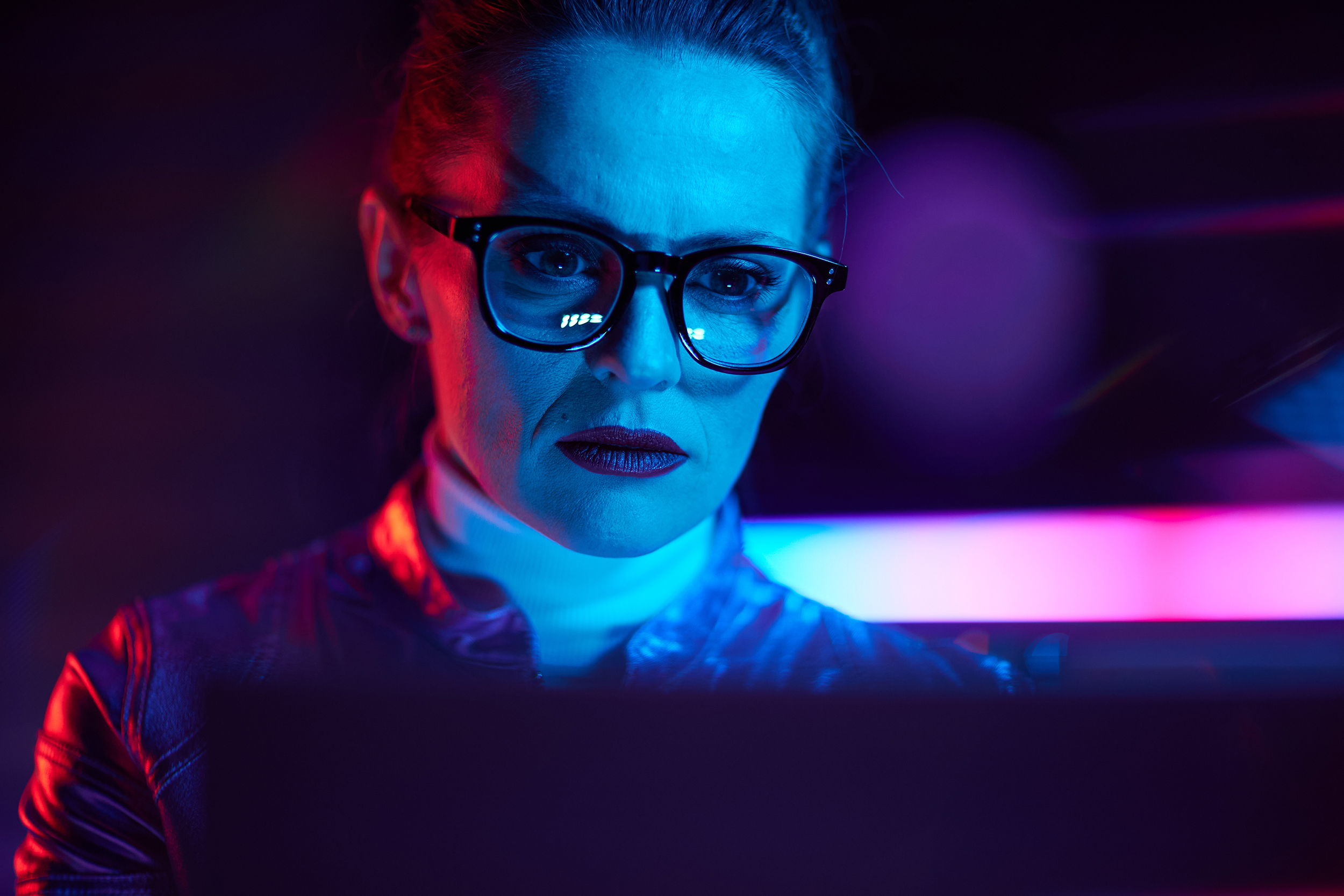 Portrait of trendy female with laptop in modern office