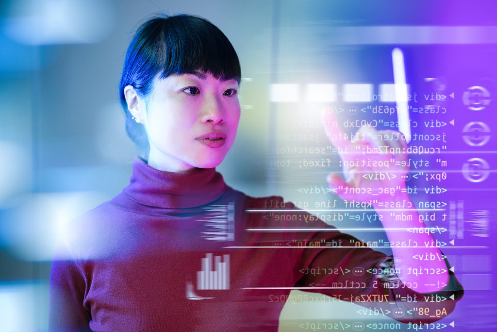 Futuristic office with Japanese mature businesswoman working on touchscreen and making decisions