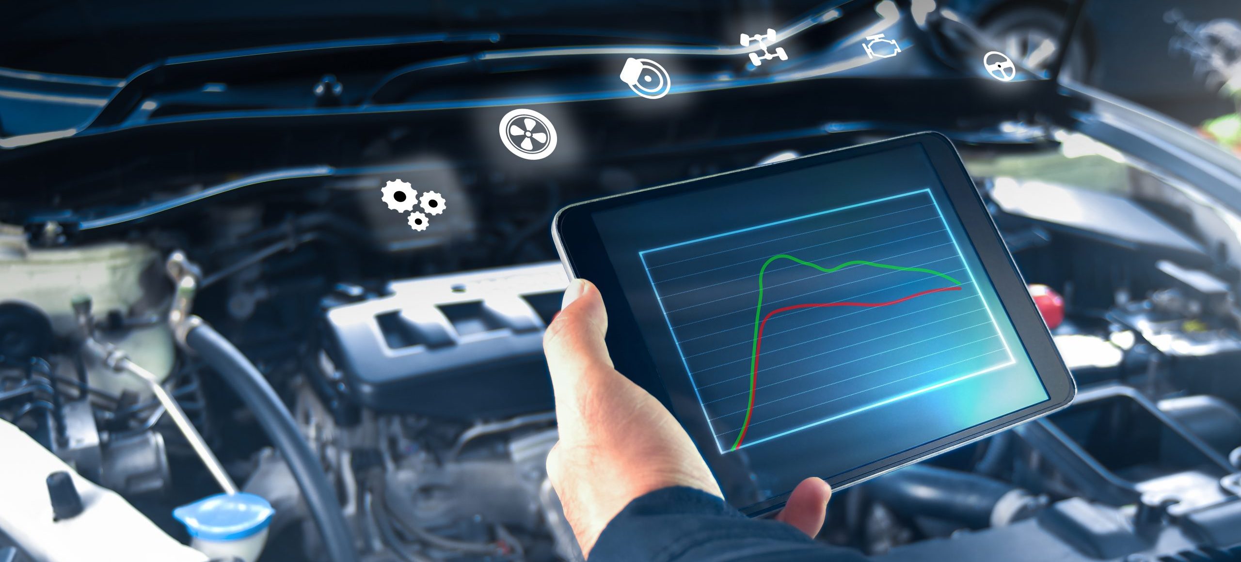 Auto mechanic is checking engine system with a ODB2 tablet and a